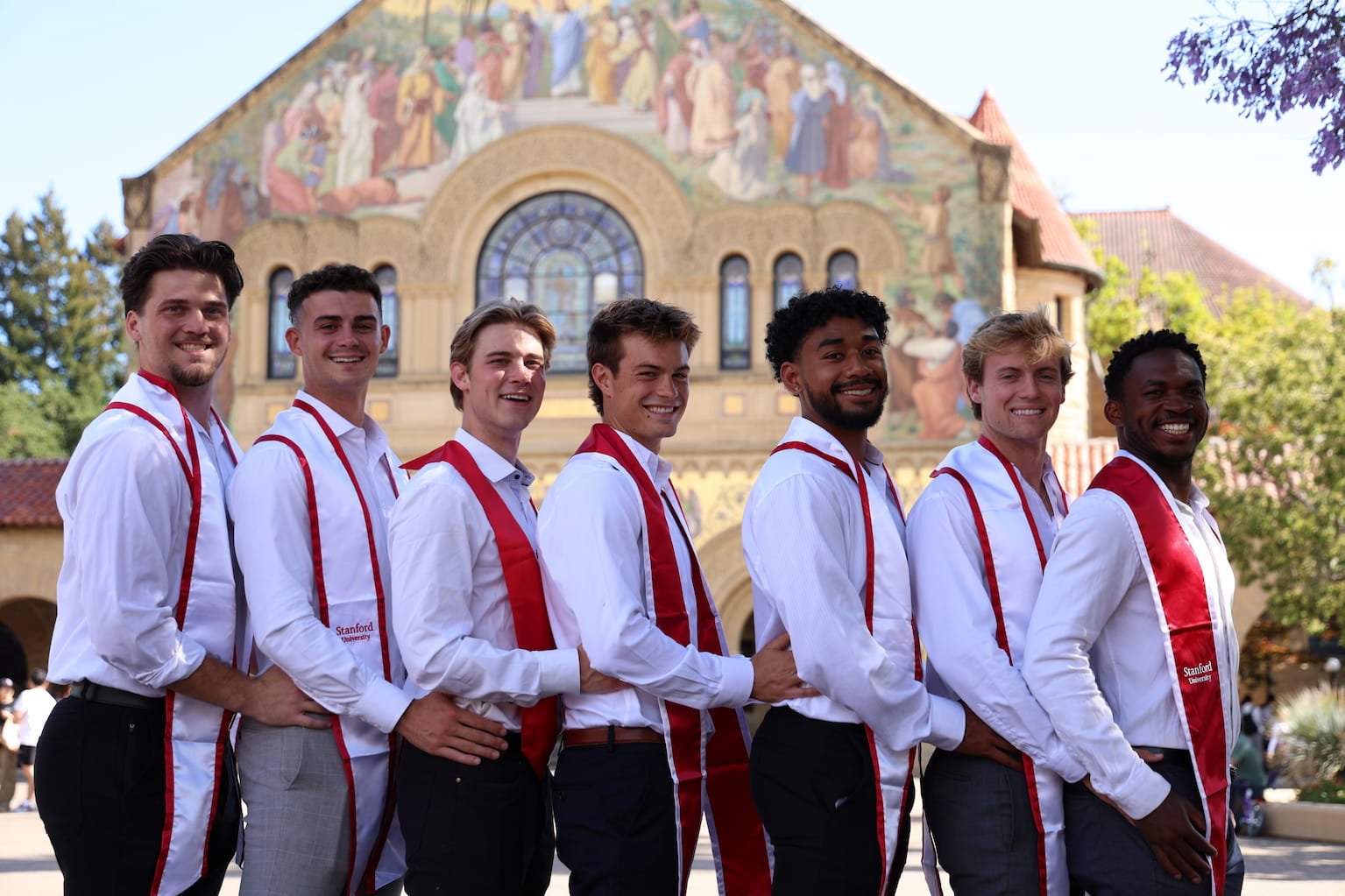 Nico standing in front of a Stanford Athletics mural